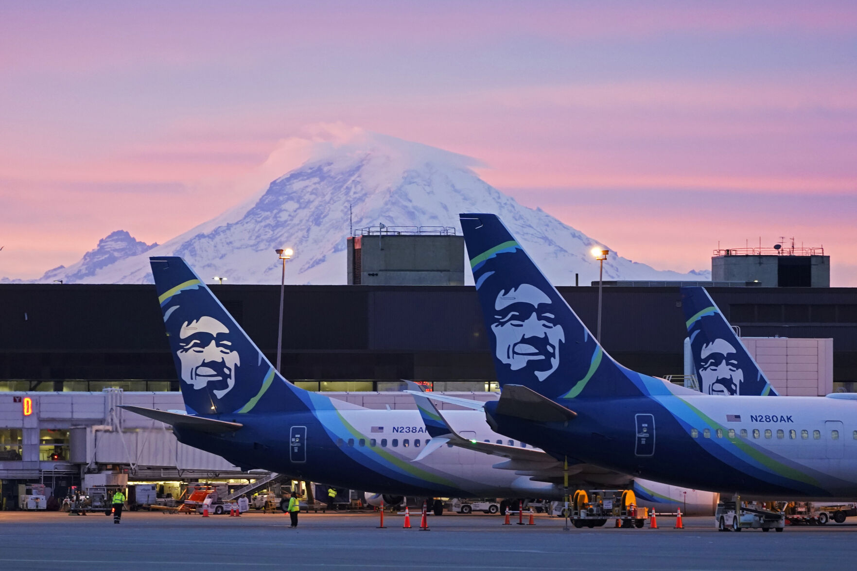 <p>FILE - Alaska Airlines planes are shown parked at gates with Mount Rainier in the background at sunrise, March 1, 2021, at Seattle-Tacoma International Airport in Seattle. (AP Photo/Ted S. Warren, File)</p>   PHOTO CREDIT: Ted S. Warren