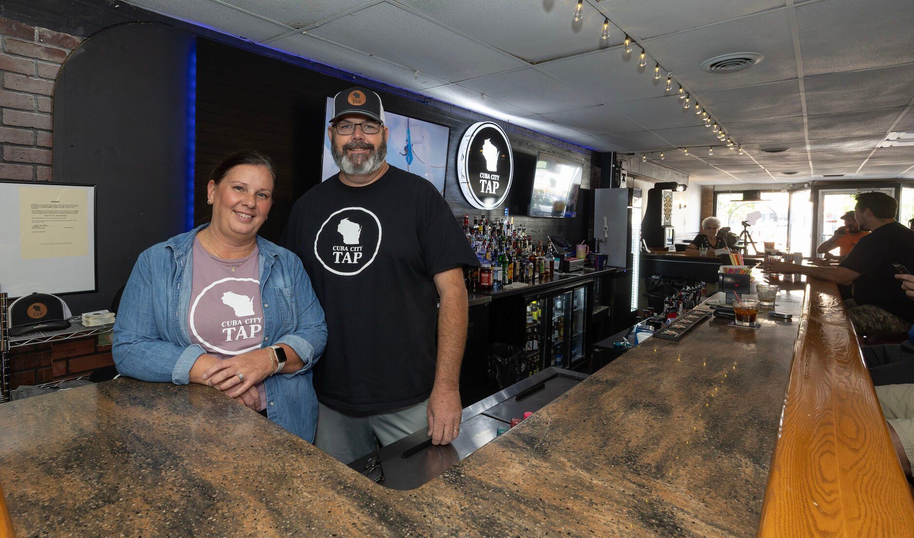 Co-owners Carrie and Jeff Mizner stand behind the bar at Cuba City Tap in Cuba City, Wis.    PHOTO CREDIT: Gassman