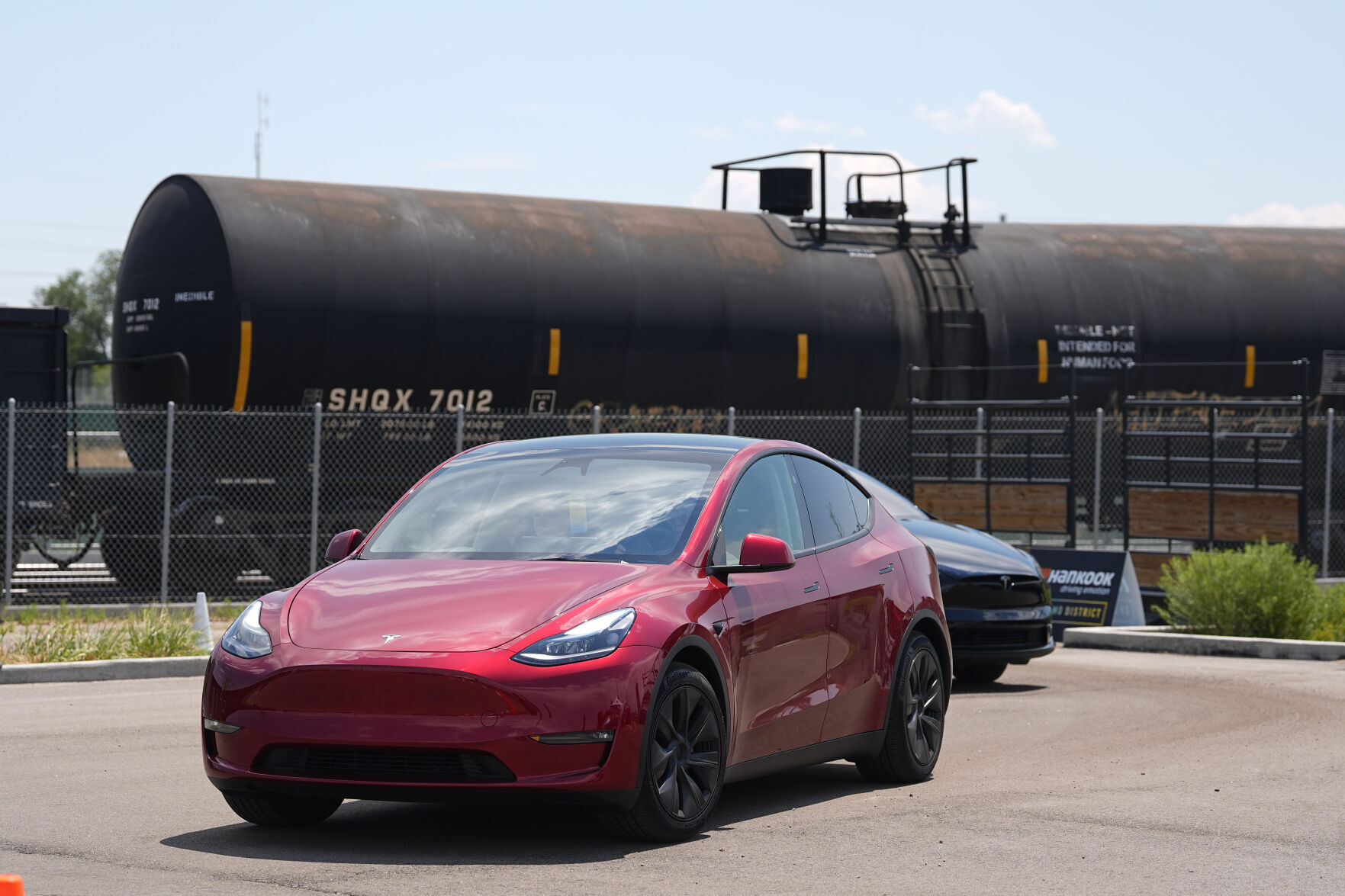 <p>FILE - Drivers guide 2024 a Tesla Model 3 sedan and Model X utility vehicle, rear, along a test track at the Electrify Expo in The Yards on July 14, 2024, in north Denver. (AP Photo/David Zalubowski, File)</p>   PHOTO CREDIT: David Zalubowski 