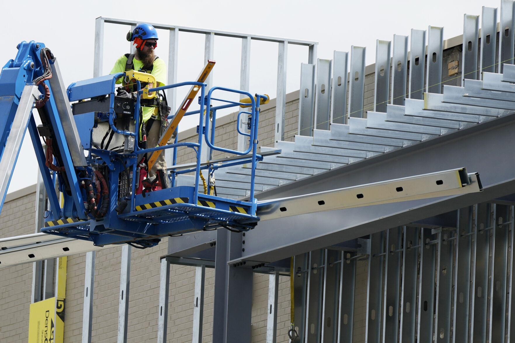 <p>A construction worker maneuvers a lift outside a commercial building site in Mount Prospect, Ill., Tuesday, Aug. 27, 2024. (AP Photo/Nam Y. Huh)</p>   PHOTO CREDIT: Nam Y. Huh 