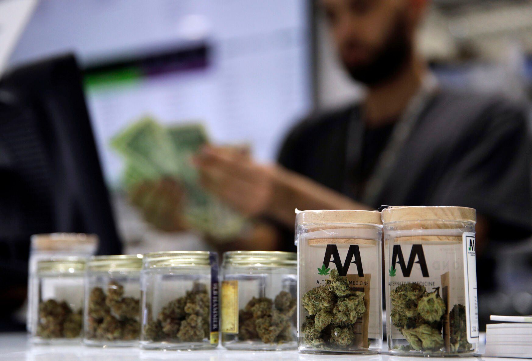 <p>FILE - A cashier rings up a marijuana sale, July 1, 2017, at a cannabis dispensary in Las Vegas. (AP Photo/John Locher, File)</p>   PHOTO CREDIT: John Locher