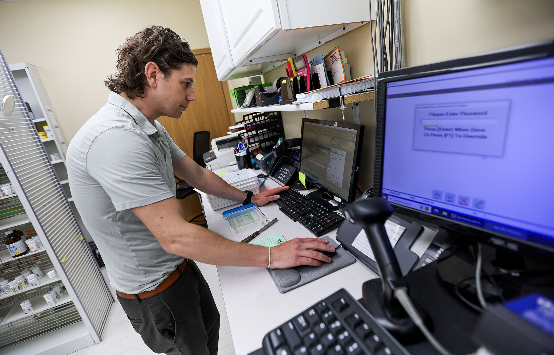 Aaron Vandermillen, Hartig Drug director of pharmacy, works on a customer’s order.    PHOTO CREDIT: Dave Kettering Telegraph Herald