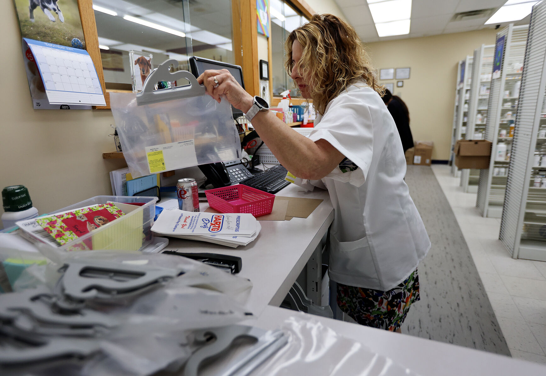 Longtime pharmacist Mary Koerperick works on orders at the Hartig Drug store on Locust Street in Dubuque.    PHOTO CREDIT: Dave Kettering Telegraph Herald