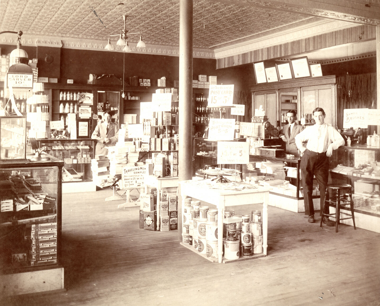 Albert J. Hartig stands inside his first store, 1904. The company now has 24 locations in Iowa, Illinois and Wisconsin, including on Locust Street in Dubuque (upper right).    PHOTO CREDIT: Contributed