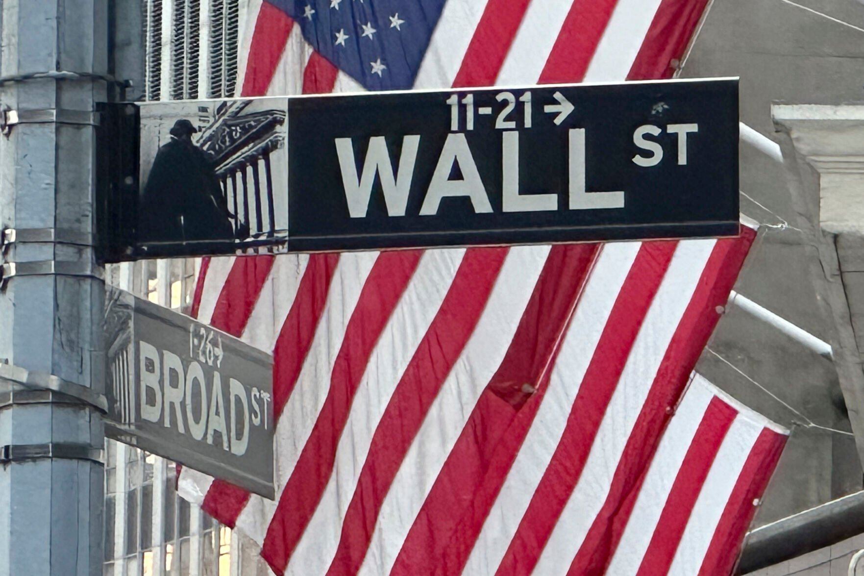 FILE - Signs at the intersection of Broad and Wall Streets stand near flags flying from the New York Stock Exchange on Sept. 4, 2024, in New York. (AP Photo/Peter Morgan, File)    PHOTO CREDIT: Associated Press