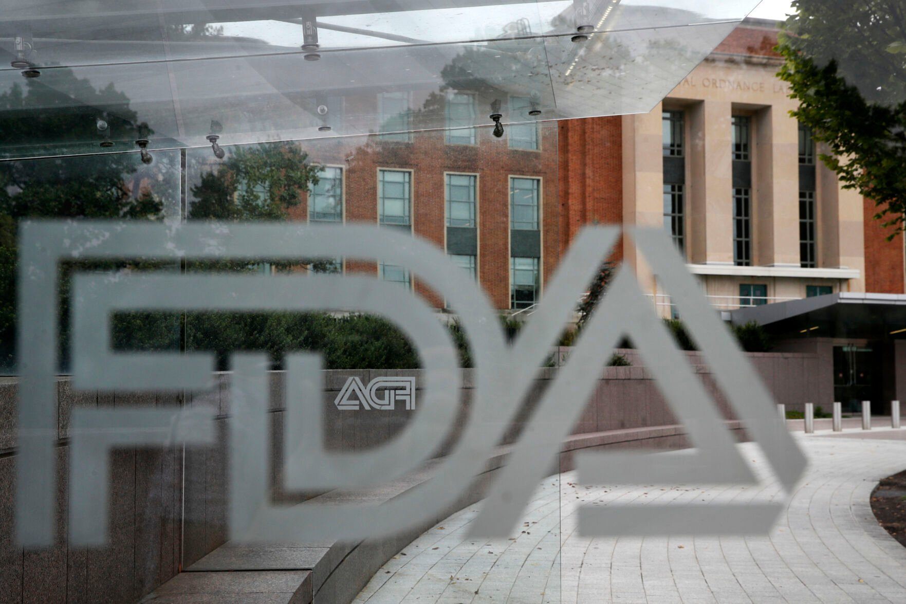 FILE - A U.S. Food and Drug Administration building is seen behind FDA logos at a bus stop on the agency