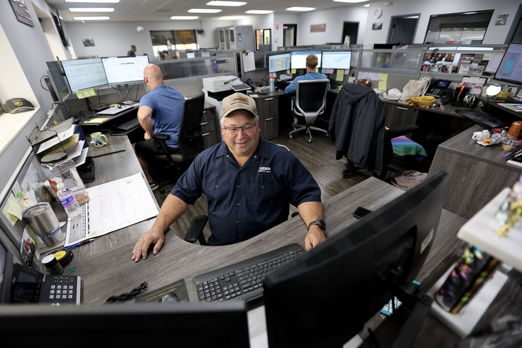 Bob Schmitt, dispatcher for Tucker Freight Lines in Dubuque, works from his desk.    PHOTO CREDIT: Dave Kettering