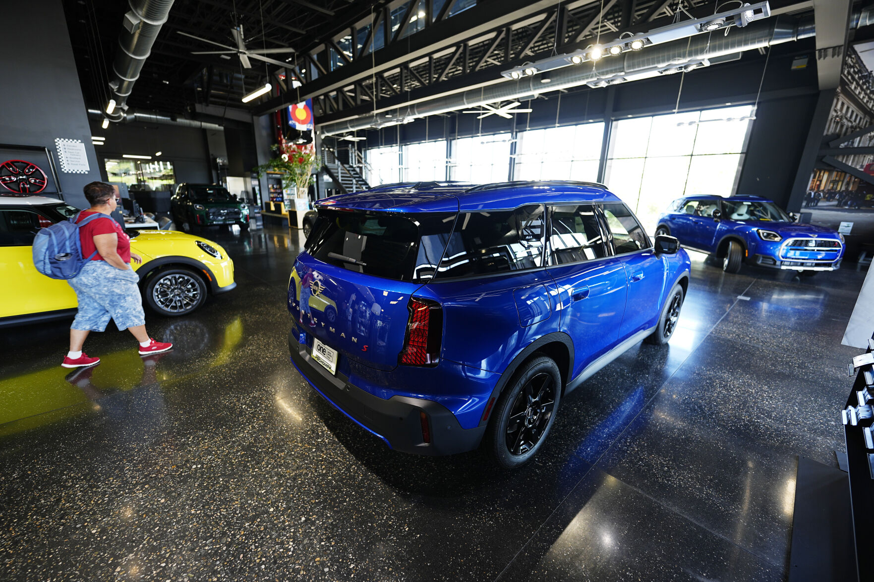 <p>A shopper looks over an unsold 2025 Cooper S hardtop on display with Countryman S utility vehicles in the showroom of a Mini dealership Wednesday, Sept. 4, 2024, in Highlands Ranch, Colo. (AP Photo/David Zalubowski)</p>   PHOTO CREDIT: David Zalubowski - staff, ASSOCIATED PRESS