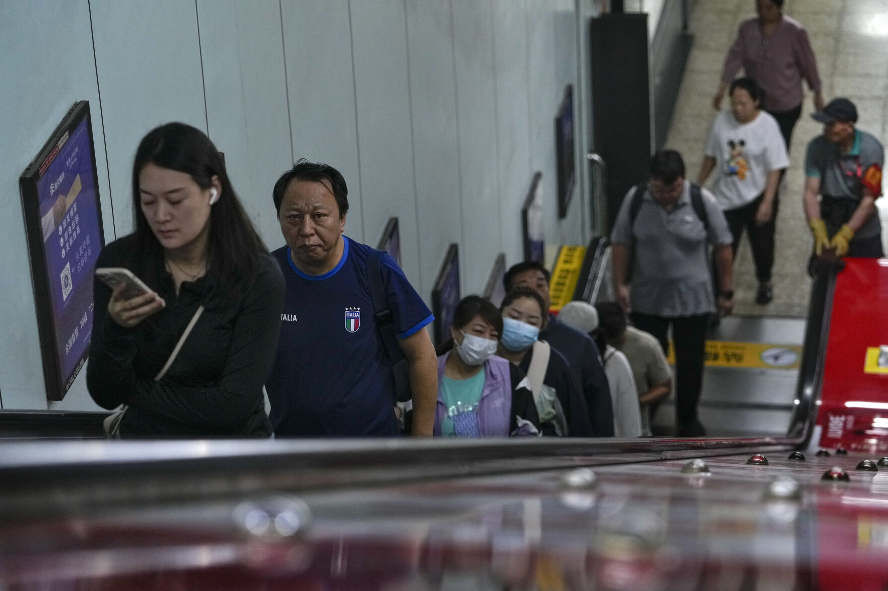 Commuters ride an escalator at a subway station during the morning rush hour in Beijing, Friday, Sept. 13, 2024. (AP Photo/Andy Wong)    PHOTO CREDIT: Associated Press