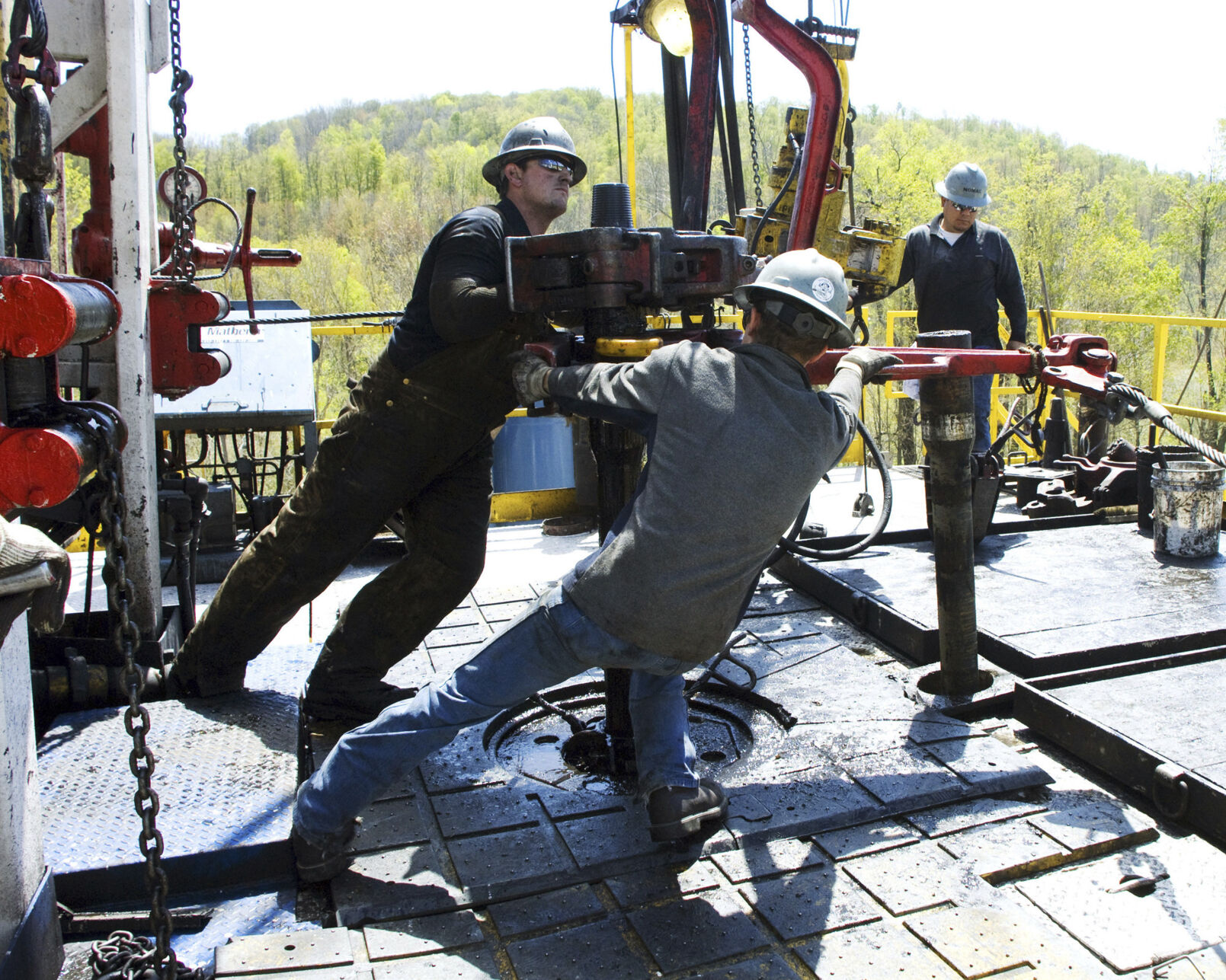 FILE - Workers move a section of well casing into place at a Chesapeake Energy natural gas well site near Burlington, Pa., in Bradford County, on April 23, 2010. (AP Photo/Ralph Wilson, File)    PHOTO CREDIT: Associated Press