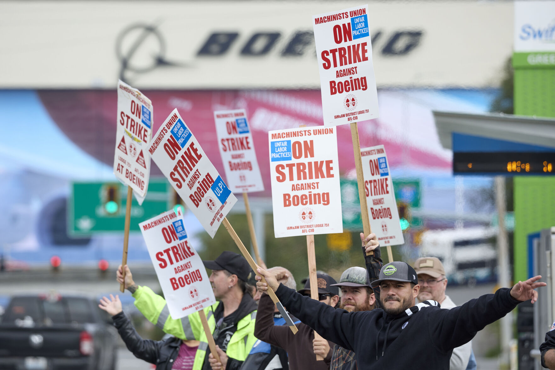 <p>Boeing Machinists Union member Nico Padilla, front, and others wave to passing traffic on the picket line at the Everett plant, Friday, Sept. 13, 2024, in Everett, Wash. (AP Photo/John Froschauer)</p>   PHOTO CREDIT: John Froschauer - freelancer, ASSOCIATED PRESS