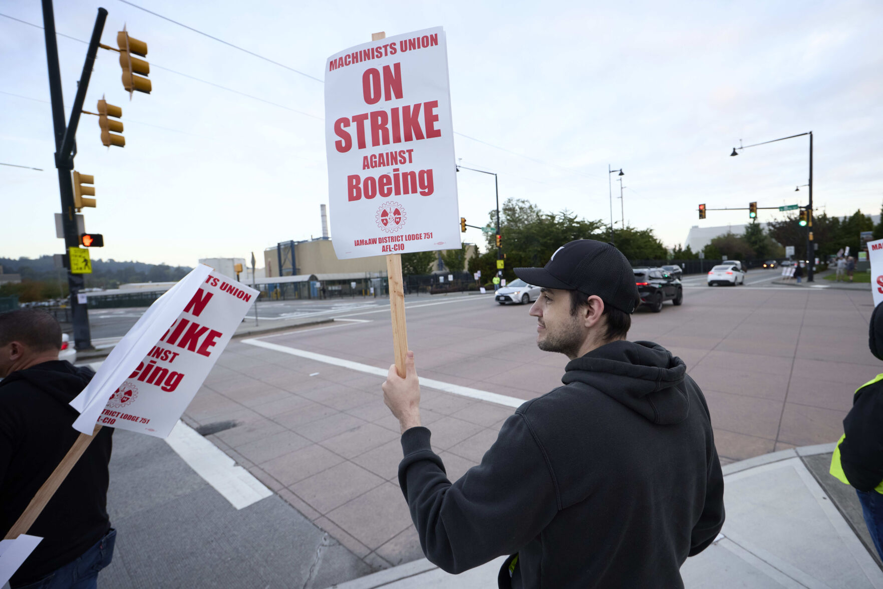 <p>Boeing Machinists Union member Andrei Cojocaru waves at passing traffic from the picket line at the Renton assembly plant, Friday, Sept. 13, 2024, in Renton, Wash. (AP Photo/John Froschauer)</p>   PHOTO CREDIT: John Froschauer - freelancer, ASSOCIATED PRESS