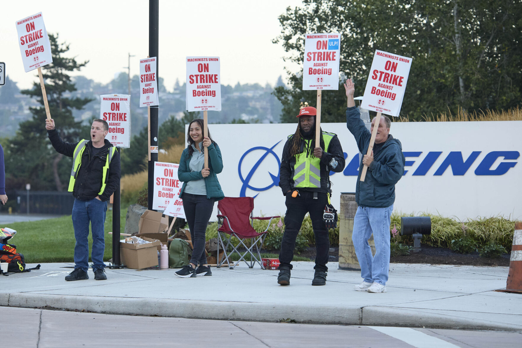 <p>Boeing Machinists Union members from left, Brent Roberts, Ha Nguyen, Myles Simms and Rich Russell, wave to passing traffic while on the picket line at the Renton assembly plant, Friday, Sept. 13, 2024, in Renton, Wash. (AP Photo/John Froschauer)</p>   PHOTO CREDIT: John Froschauer - freelancer, ASSOCIATED PRESS