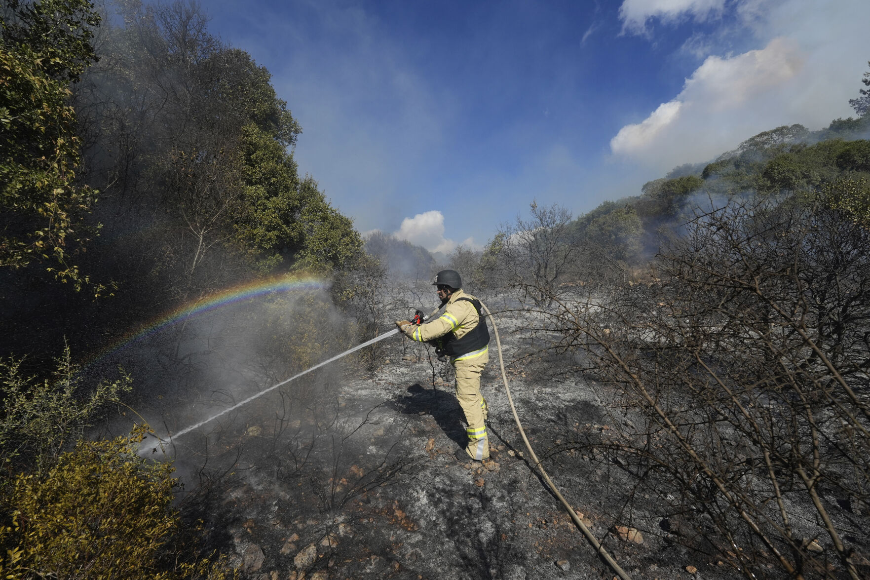 <p>An Israeli firefighter works to extinguish a fire after a rocket fired from Lebanon hit an open field in northern Israel, Wednesday, Sept. 18, 2024. (AP Photo/Baz Ratner)</p>   PHOTO CREDIT: Baz Ratner 