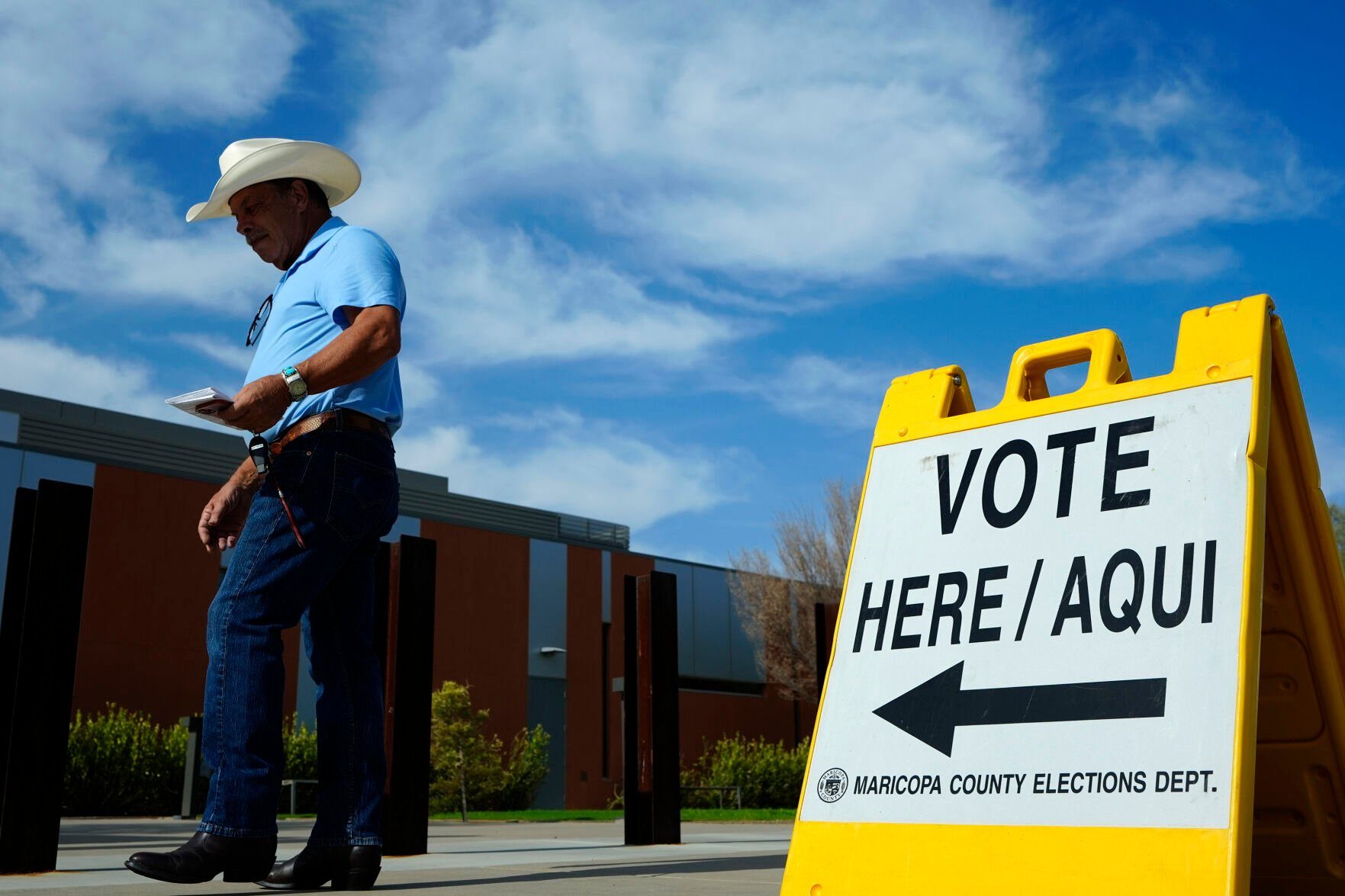 FILE - A voter walks to a voting precinct prior to casting his ballot in the state