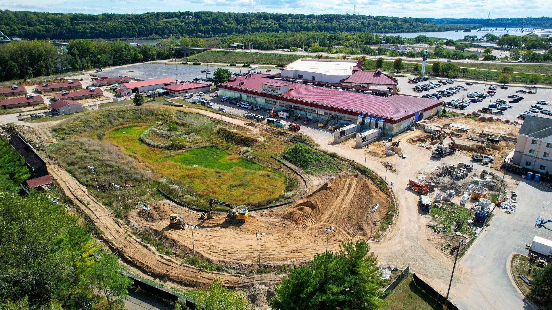 Construction continues on the Key Hotel (right) at the Q Casino + Resort on Chaplain Schmitt Island on Tuesday. A golf-entertainment complex is planned for the site of the former greyhound race track (foreground).    PHOTO CREDIT: Dave Kettering