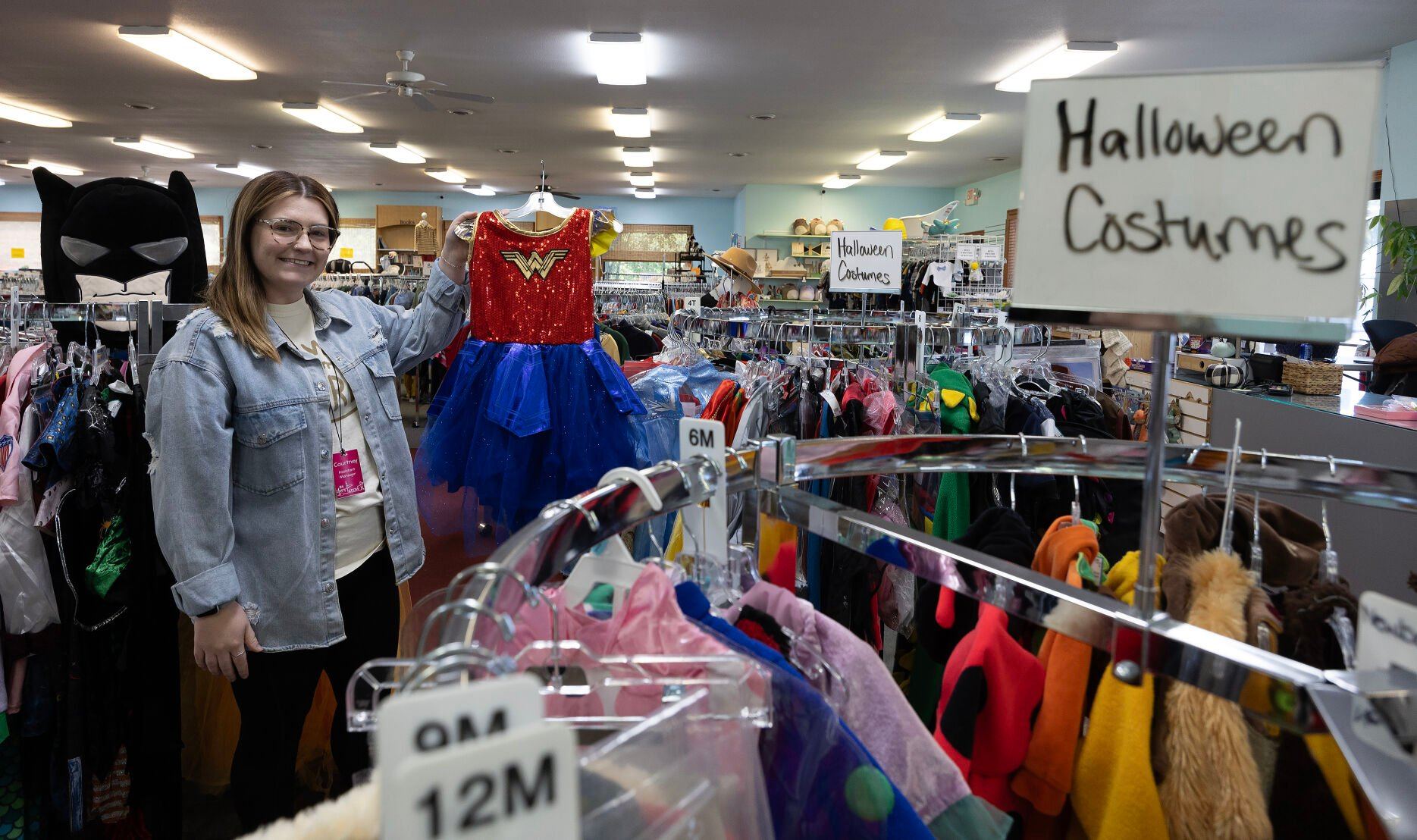 Assistant manager Courtney Gebke shows a Halloween costume at As They Grow in Dubuque on Tuesday.    PHOTO CREDIT: Gassman