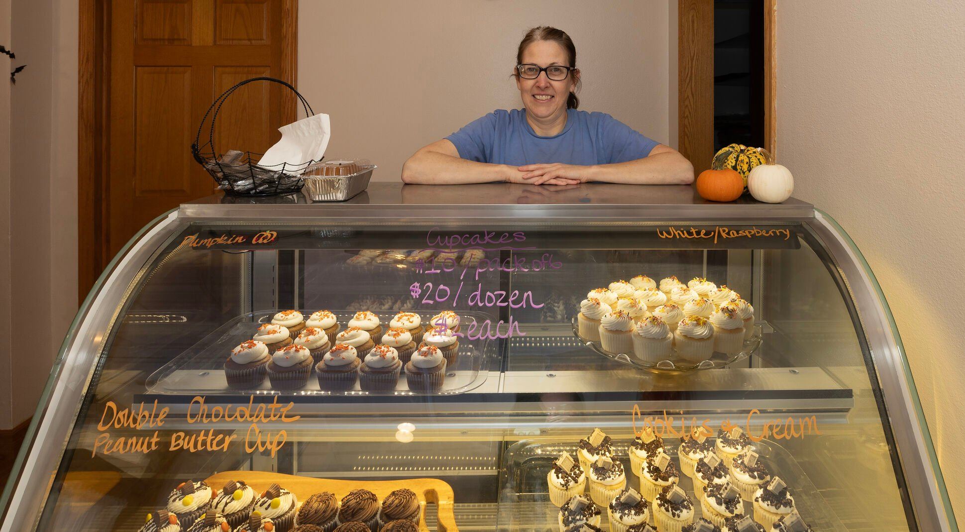 Owner Angie Freed stands behind a display case at Cake and Eat it Too in Platteville, Wis., on Wednesday.    PHOTO CREDIT: Gassman