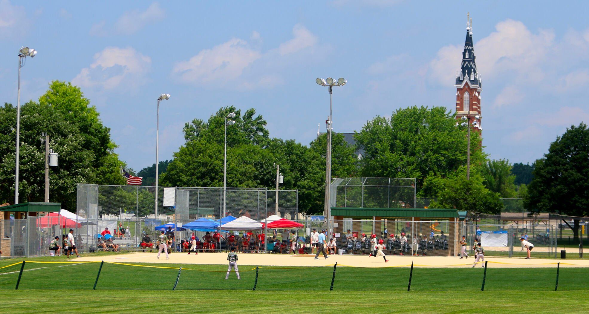 Kids take the field during the Field of Dreams baseball tournament at Westside Park in Dyersville, Iowa.    PHOTO CREDIT: Dave Kettering