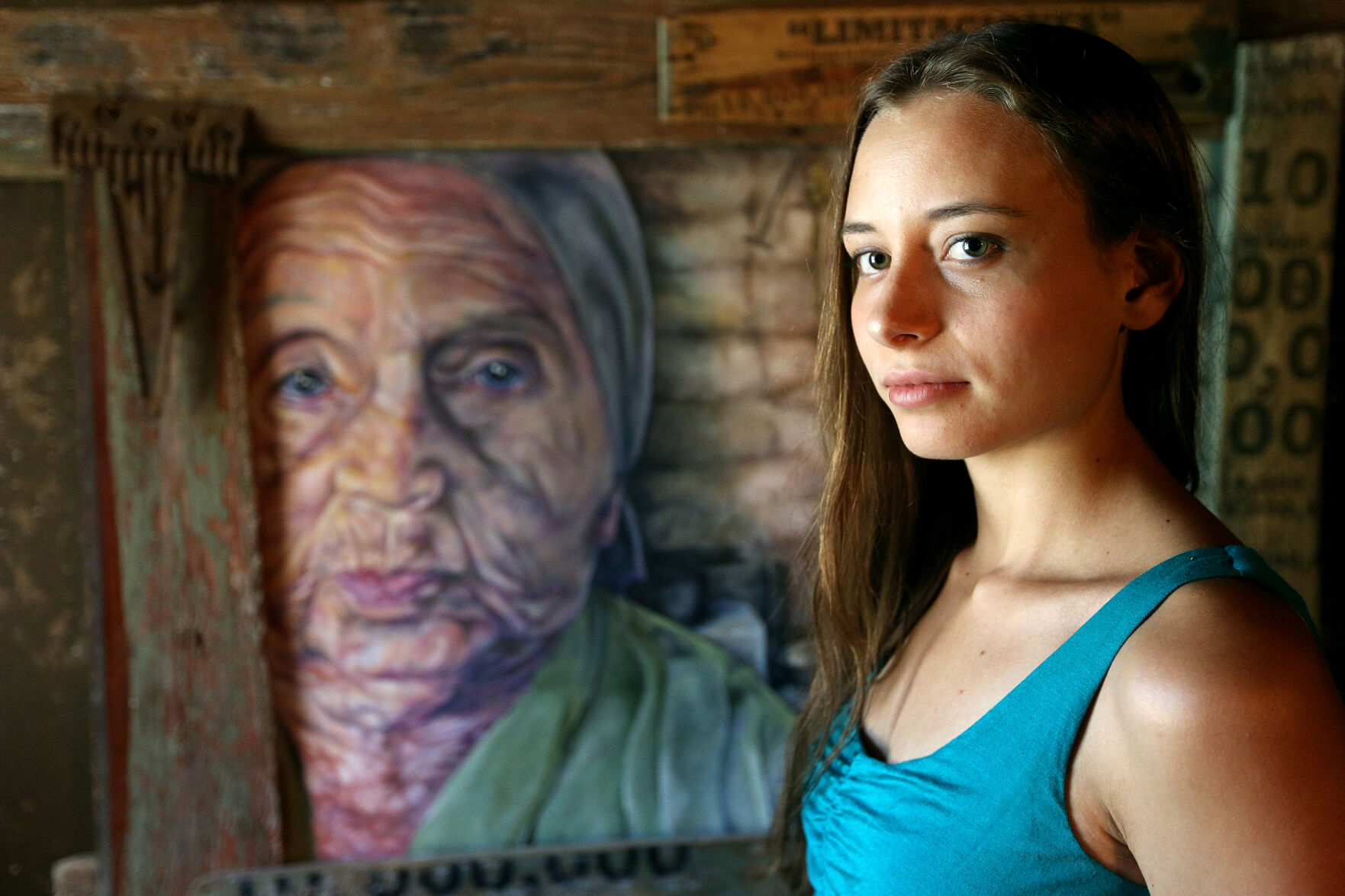 Artist Ivonne Simonds with one of her pieces on display at the Nash Gallery in Dubuque.    PHOTO CREDIT: Dave Kettering