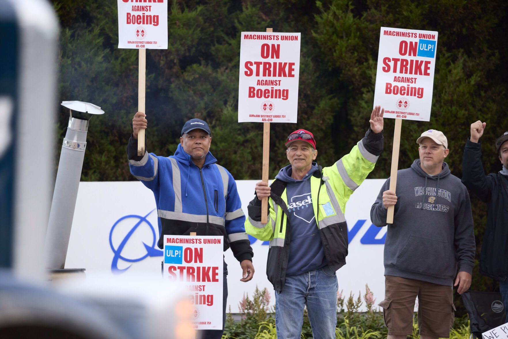 <p>Boeing Machinists Union members Steven Wilson, left, Dave Hendrickson, center,, and Mark Erickson, right, wave to passing traffic while on the picket line at the Renton assembly plant, Friday, Sept. 13, 2024, in Renton, Wash. (AP Photo/John Froschauer)</p>   PHOTO CREDIT: John Froschauer 