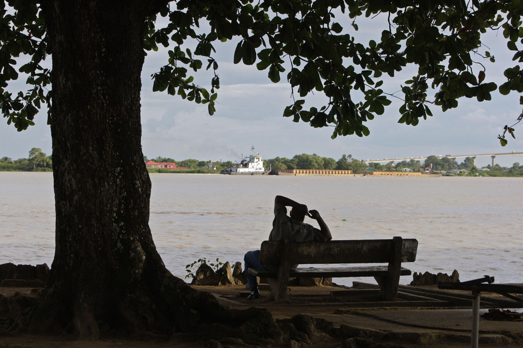 <p>FILE - A man sits on the banks of the Suriname River in Paramaribo, Suriname, Aug. 10, 2010. (AP Photo/Andres Leighton, File)</p>   PHOTO CREDIT: Andres Leighton 