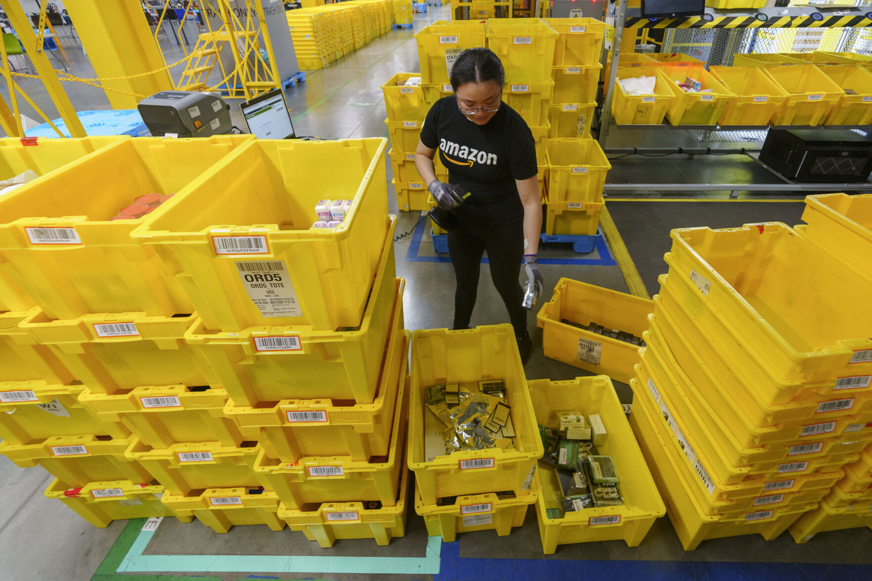 <p>FILE - An employee scans incoming items at a receiving station at the Amazon OXR1 fulfillment center in Oxnard, Calif., on Aug. 21, 2024. (AP Photo/Damian Dovarganes, File)</p>   PHOTO CREDIT: Damian Dovarganes - staff, ASSOCIATED PRESS