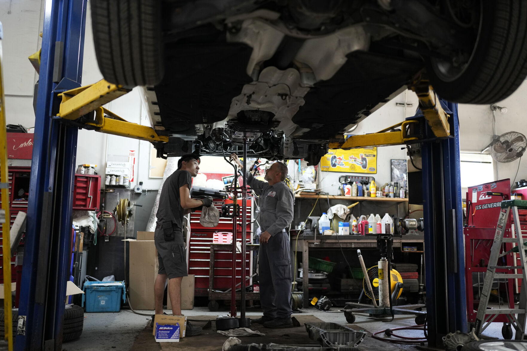 <p>FILE - Auto mechanics work on a vehicle at the Express Auto Service Inc., in Chicago, Sept. 19, 2024. (AP Photo/Nam Y. Huh, File)</p>   PHOTO CREDIT: Nam Y. Huh - staff, ASSOCIATED PRESS