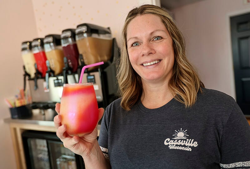 Owner of The Neighborhood Slush Carrie Wunderlin holds one of her wine slush drinks at her business located in Cassville, Wis.    PHOTO CREDIT: Dave Kettering