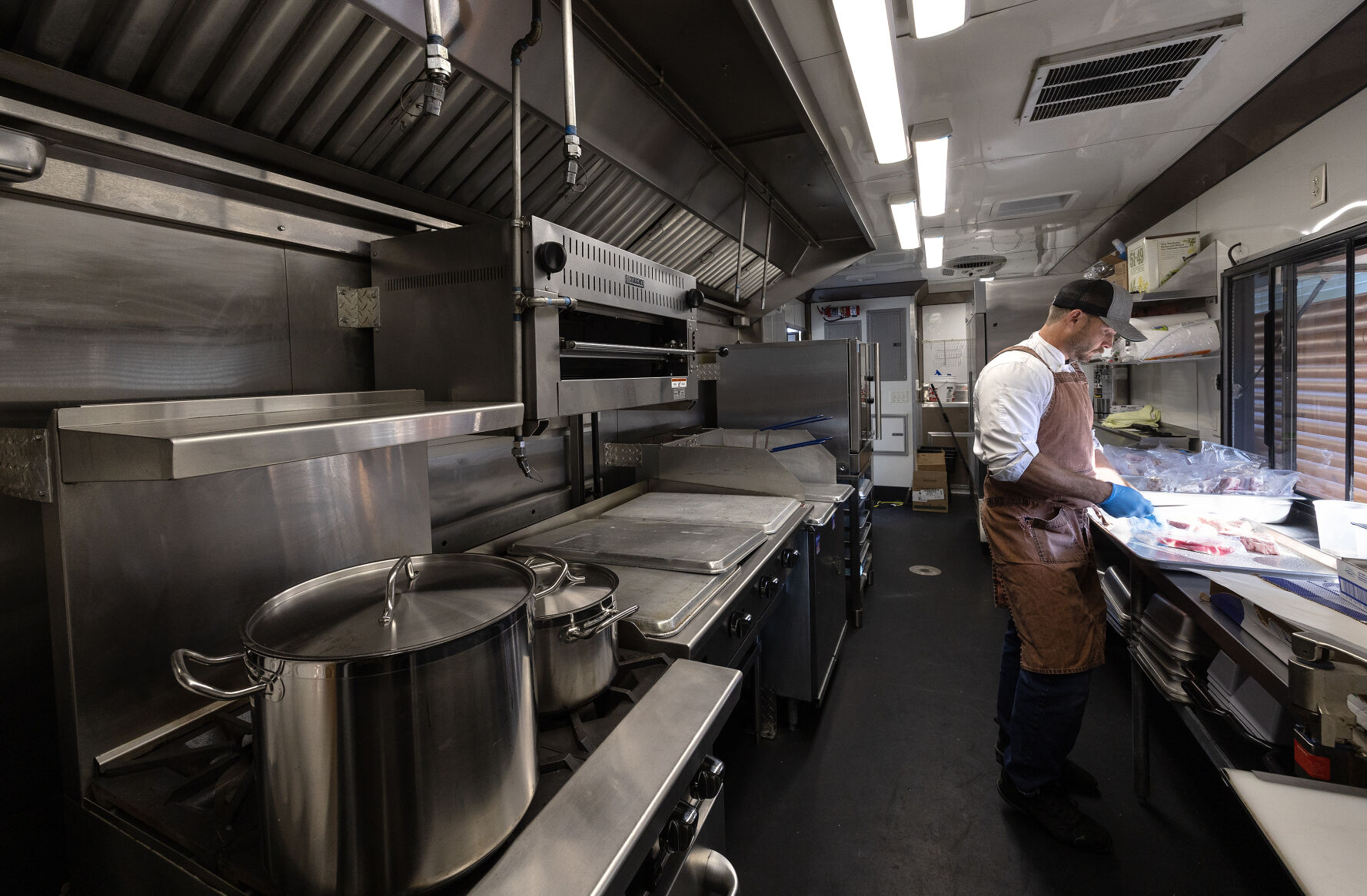 Apple Blossom Catering owner chef Jason Culbertson works in his catering trailer in Dubuque on Thursday, Oct. 10, 2024.    PHOTO CREDIT: Stephen Gassman