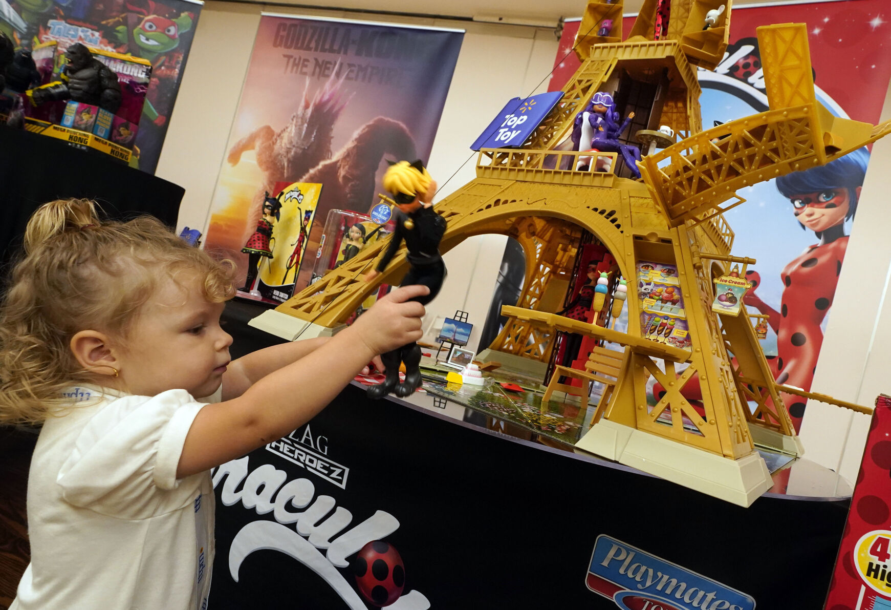 <p>FILE - Reggie Rose Geschke, 2, plays with the Miraculous Paris Heroes Playset, from Playmates Toys, at the TTPM 2024 Holiday Showcase event, in New York, Sept. 17, 2024. (AP Photo/Richard Drew, File)</p>   PHOTO CREDIT: Richard Drew 