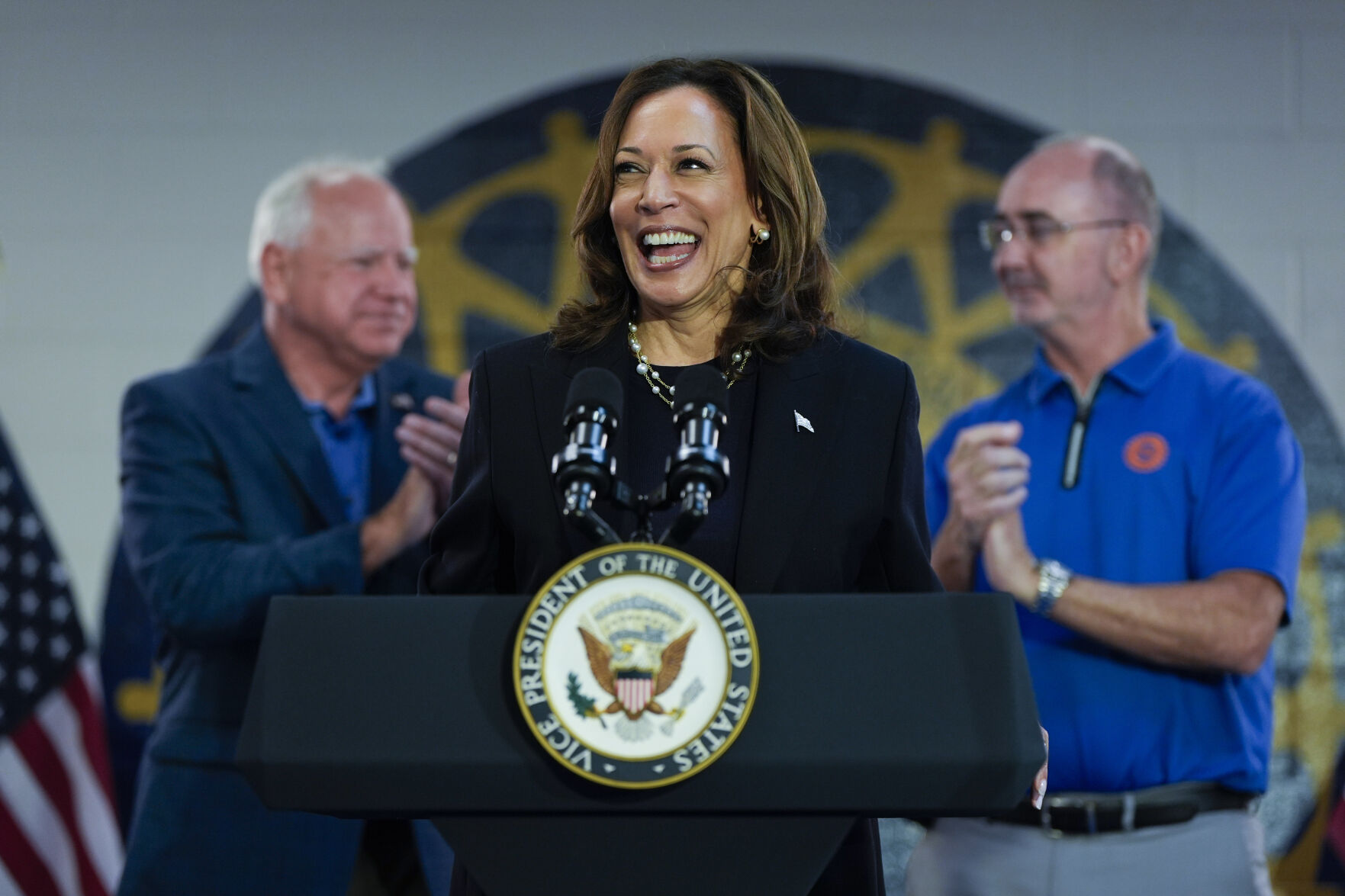 <p>FILE - Democratic presidential nominee Vice President Kamala Harris, with Democratic vice presidential nominee Minnesota Gov. Tim Walz, left, and UAW President Shawn Fain, speaks at a campaign rally at UAW Local 900, Aug. 8, 2024, in Wayne, Mich. (AP Photo/Julia Nikhinson, File)</p>   PHOTO CREDIT: Julia Nikhinson 