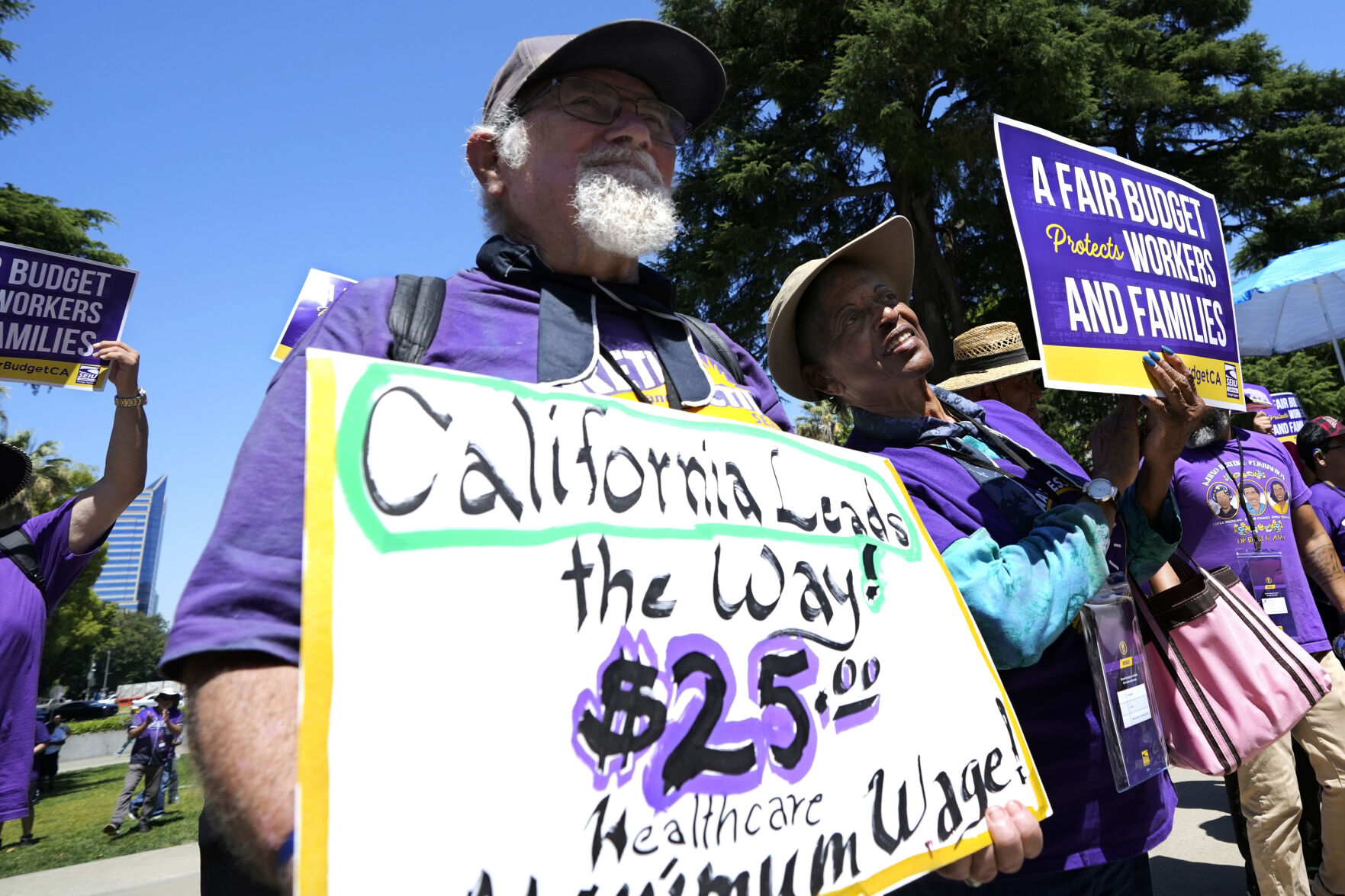 <p>FILE - Retirees Ron Martin, left, and Willie Mae Hampton, right, join other supporters of the Service Employees International Union at a rally against proposed budget cuts to state provided social safety net programs, in Sacramento, Calif., Tuesday, June 11, 2024. (AP Photo/Rich Pedroncelli, File)</p>   PHOTO CREDIT: Rich Pedroncelli