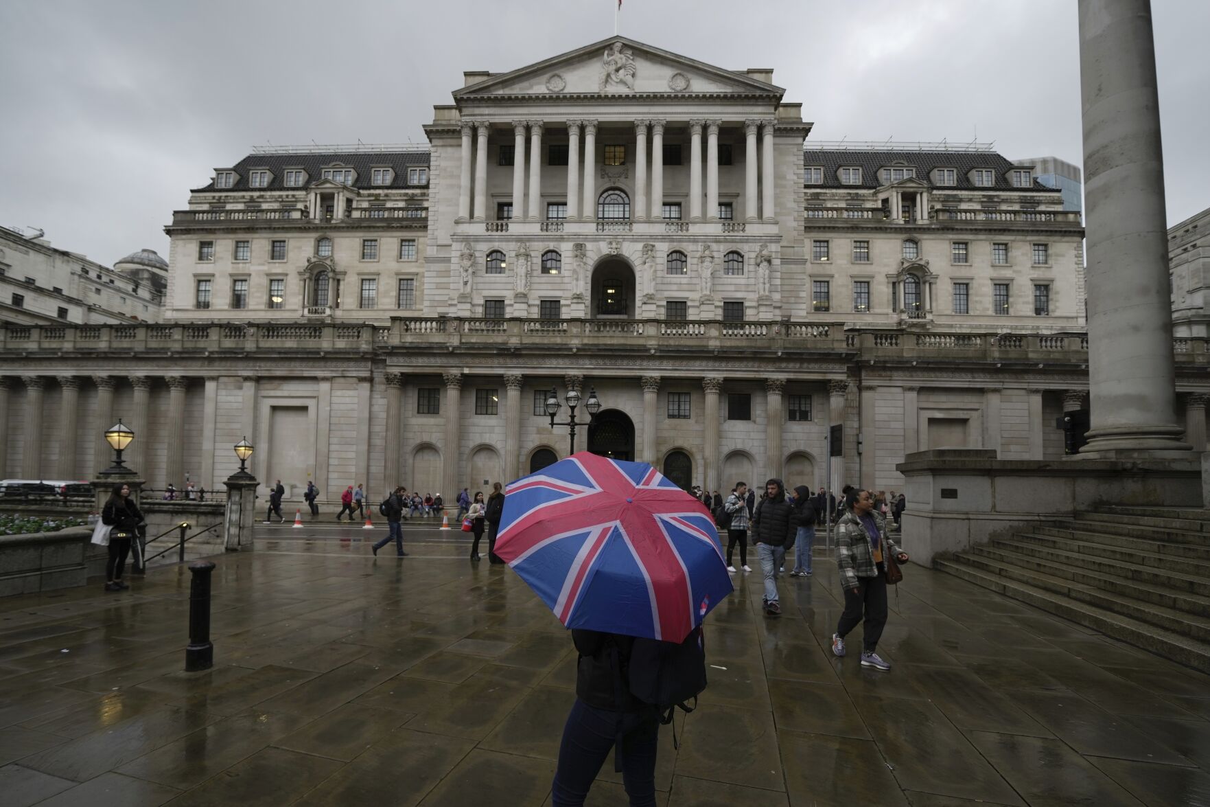 <p>FILE -A woman with an umbrella stands in front of the Bank of England, at the financial district in London, , Nov. 3, 2022. (AP Photo/Kin Cheung, File)</p>   PHOTO CREDIT: Kin Cheung