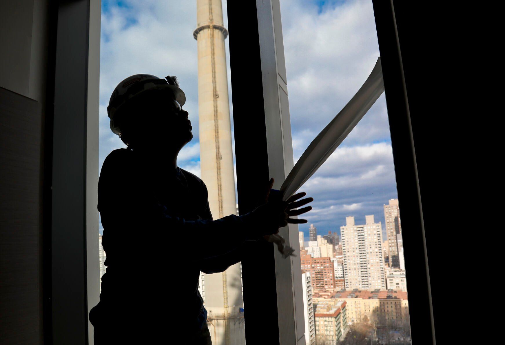 <p>FILE - Construction laborer Myrtle Wilson prepares for a the installation of windows on a building on Jan. 9, 2019 in New York. (AP Photo/Bebeto Matthews, File)</p>   PHOTO CREDIT: Bebeto Matthews 