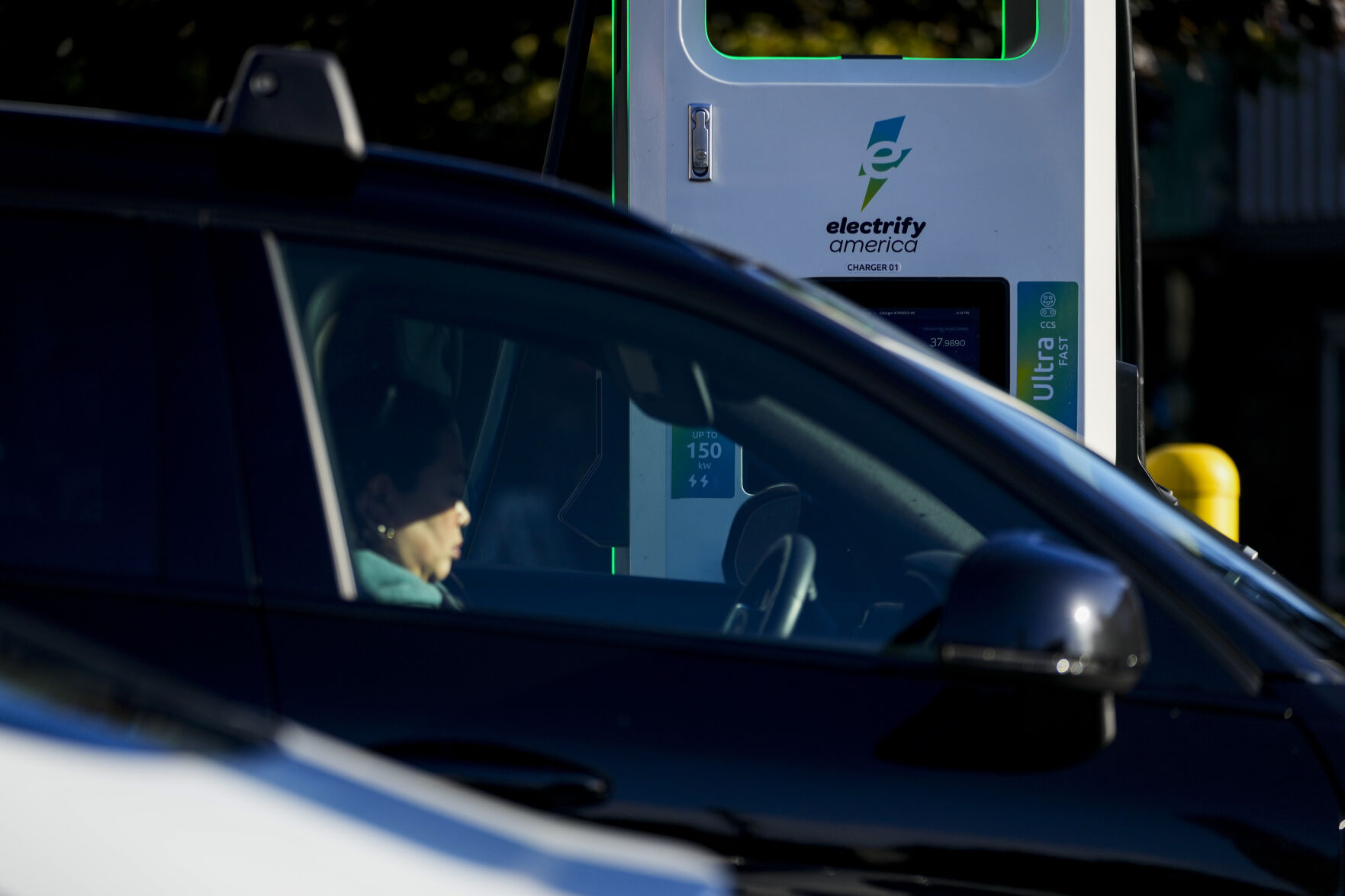 <p>FILE - A driver waits in their car while charging their electric vehicles at an Electrify America station, Oct. 9, 2024, in Seattle. (AP Photo/Lindsey Wasson, File)</p>   PHOTO CREDIT: Lindsey Wasson - staff, ASSOCIATED PRESS