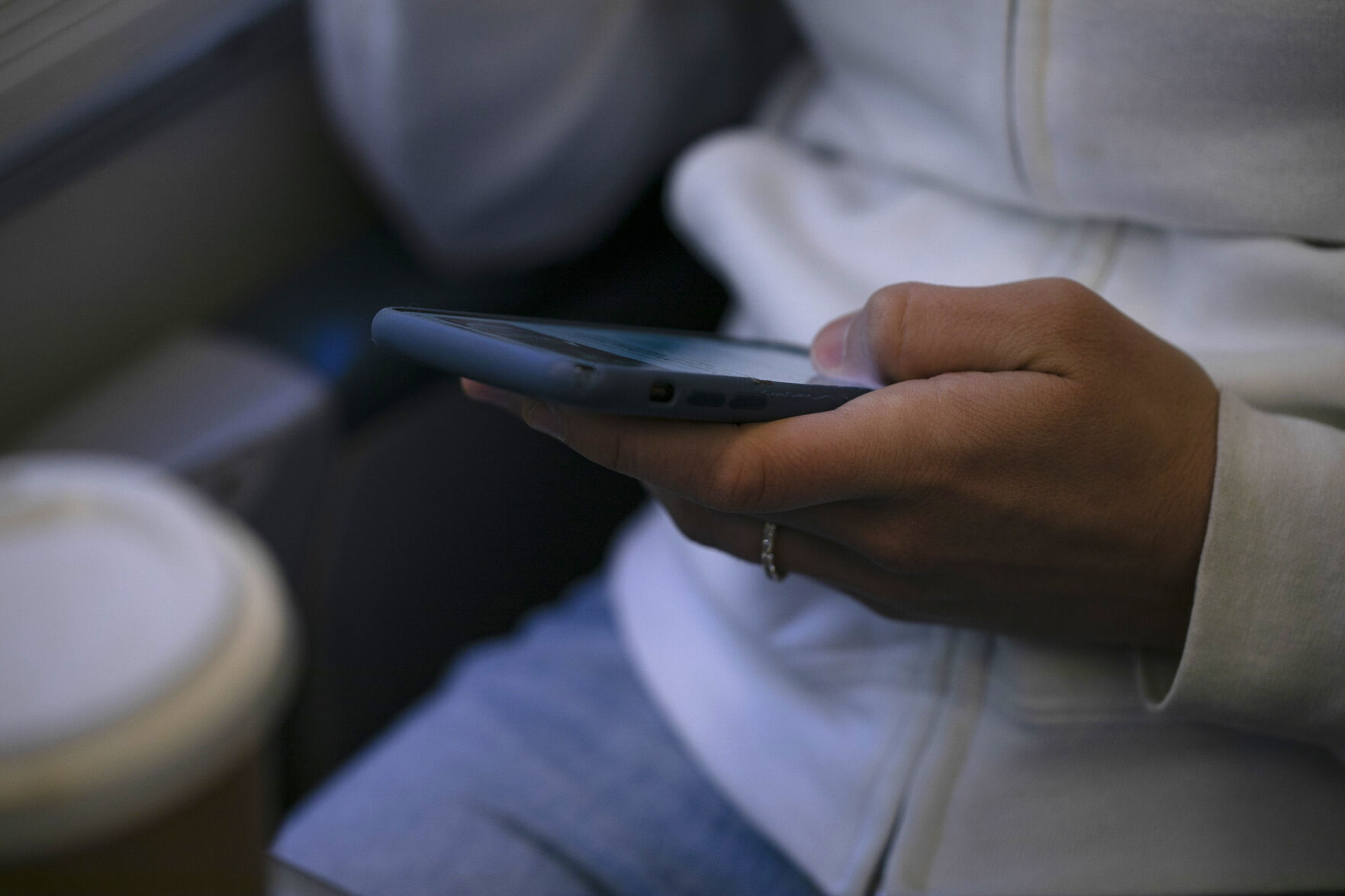 <p>FILE - A woman looks at a hand held device on a train in New Jersey on May 18, 2021. (AP Photo/Jenny Kane, File)</p>   PHOTO CREDIT: Jenny Kane - staff, ASSOCIATED PRESS