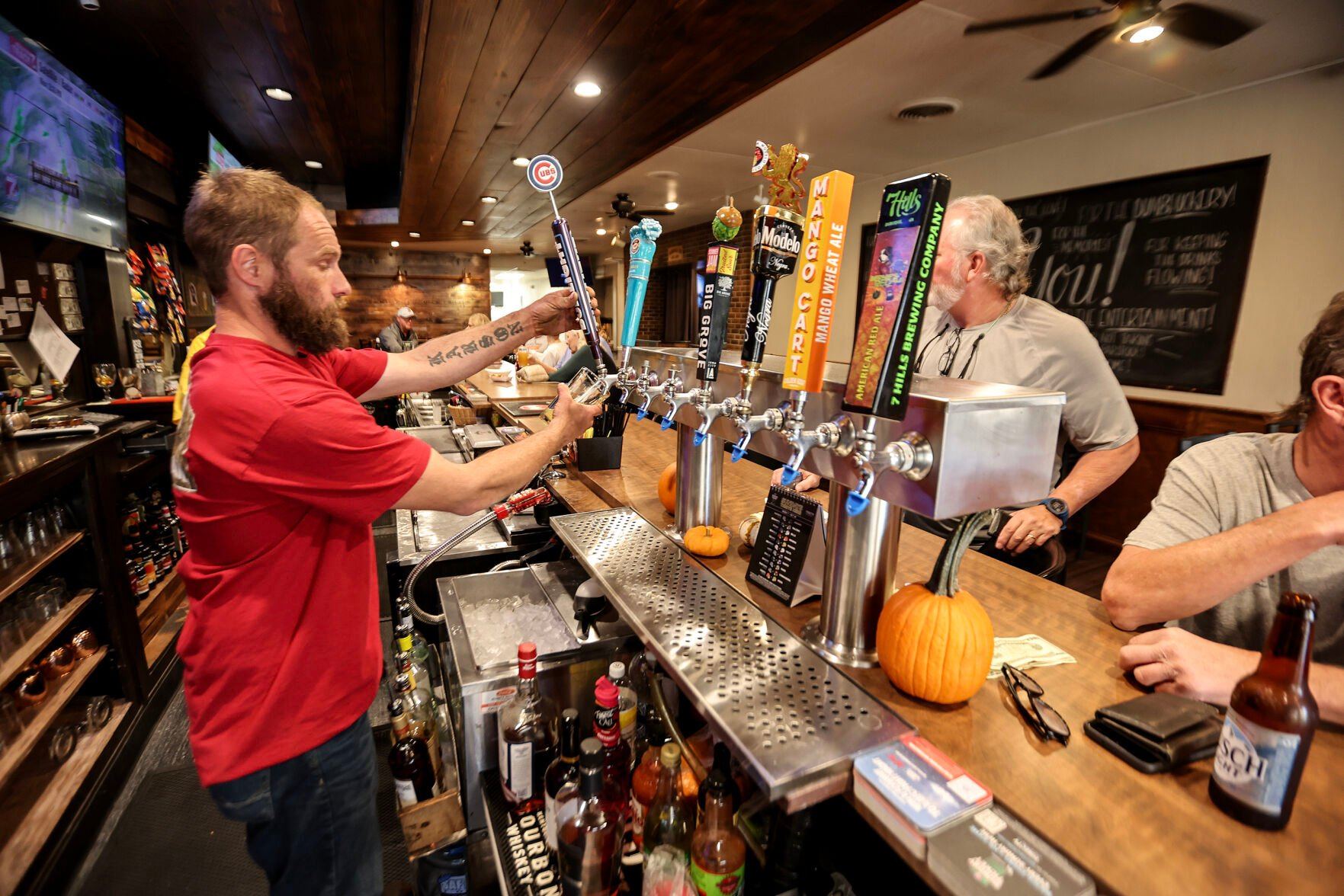 Co-owner of the 1891 Saloon & Eatery in Cascade, Iowa, Brandon Streets, pours a beer for a customer on Monday, Oct. 21, 2024.    PHOTO CREDIT: Dave Kettering