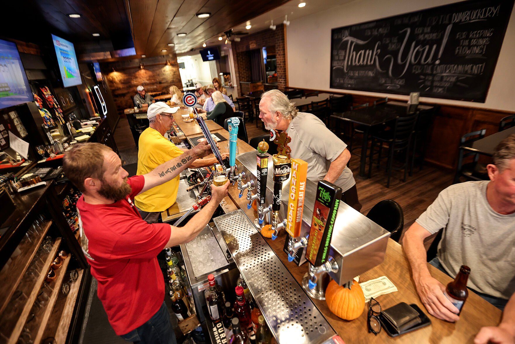 Co-owner of the 1891 Saloon & Eatery in Cascade, Iowa, Brandon Streets, pours a beer for a customer on Monday, Oct. 21, 2024.    PHOTO CREDIT: Dave Kettering