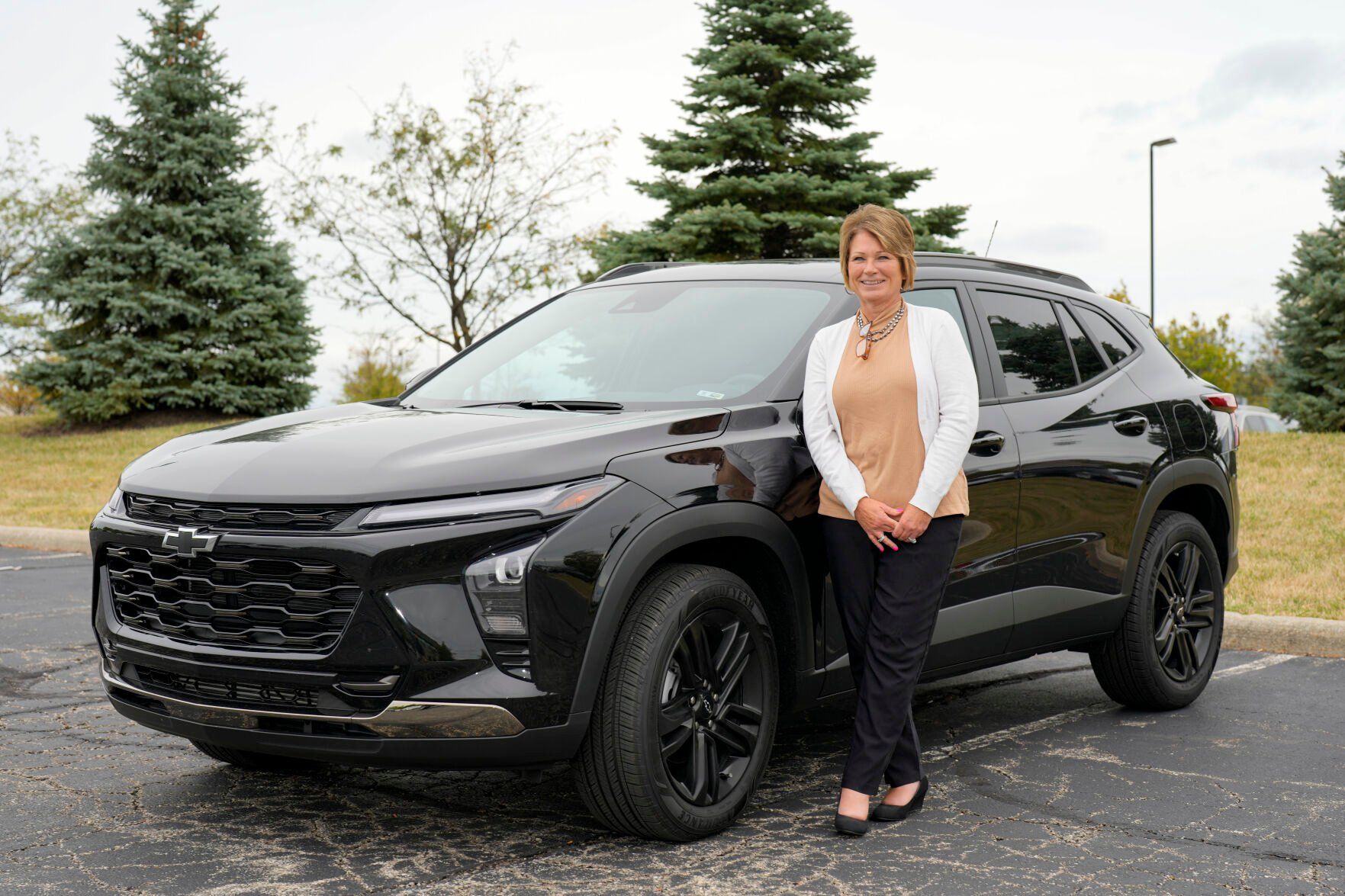 <p>Michelle Chumley poses for a portrait beside her new Chevrolet Trax compact SUV, Thursday, Sept. 26, 2024, in West Chester, Ohio. (AP Photo/Jeff Dean)</p>   PHOTO CREDIT: Jeff Dean 