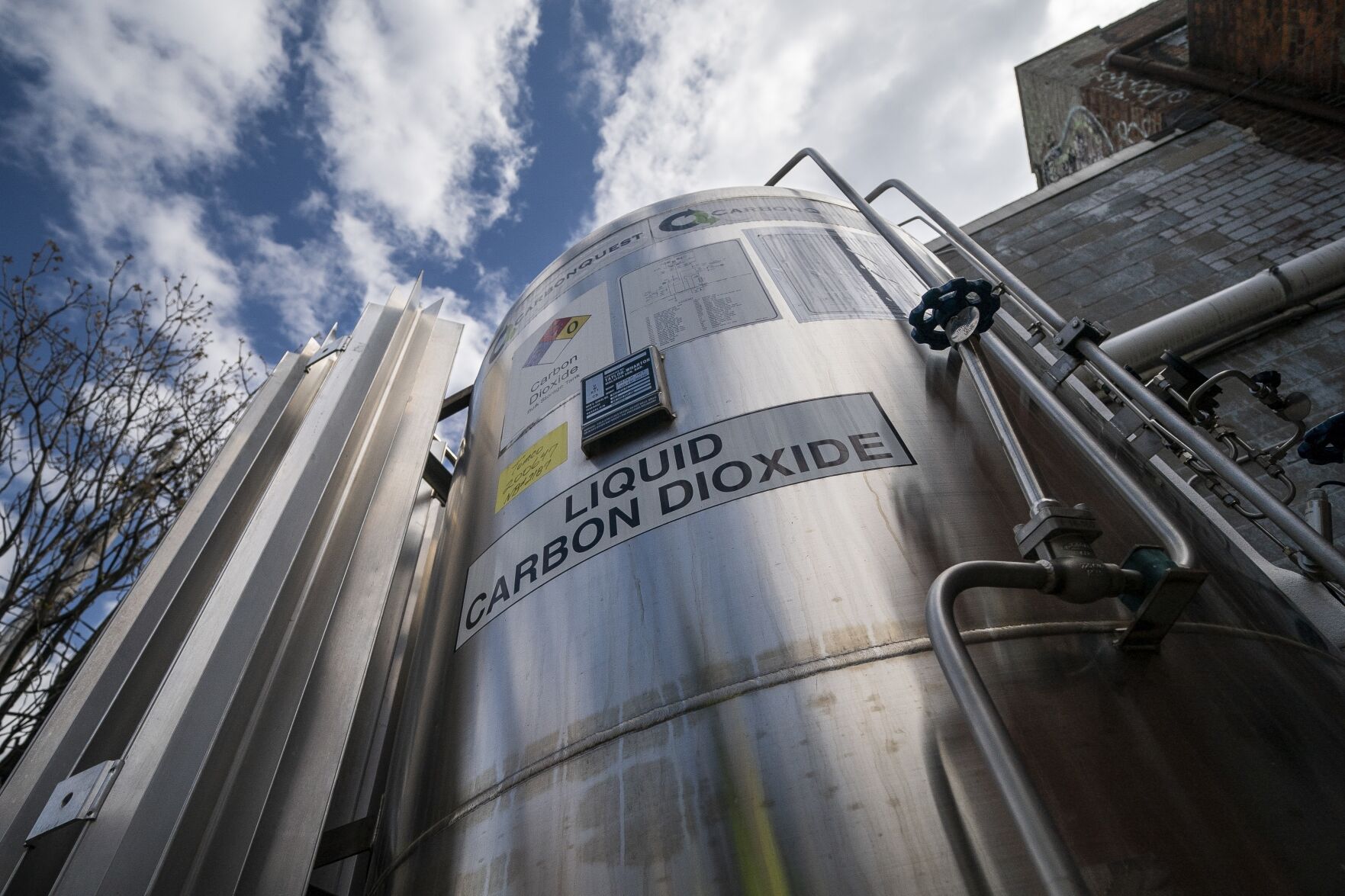 <p>FILE - A liquid carbon dioxide containment unit stands outside the fabrication building of Glenwood Mason Supply Company, April 18, 2023, in the Brooklyn borough of New York. (AP Photo/John Minchillo, File)</p>   PHOTO CREDIT: John Minchillo 