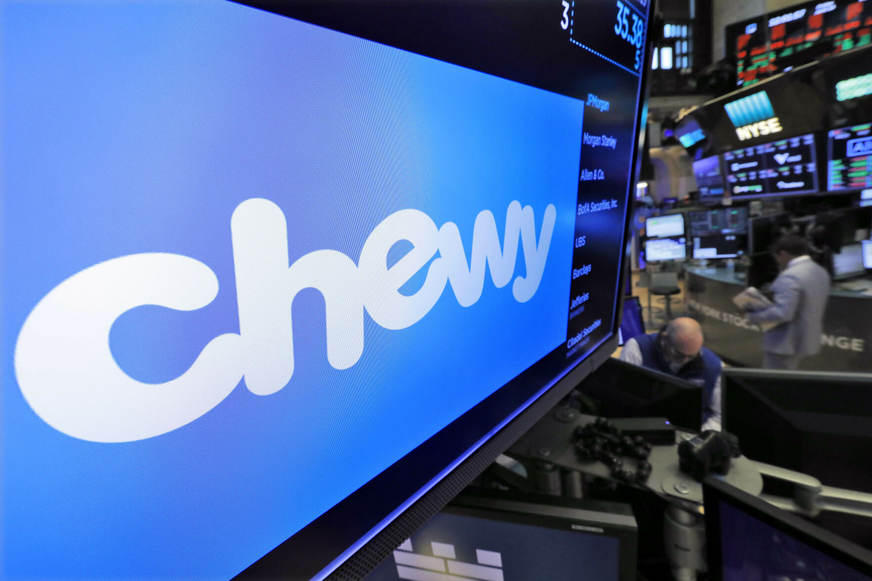 <p>FILE - The logo for Chewy appears above trading posts on the floor of the New York Stock Exchange, June 14, 2019. (AP Photo/Richard Drew, File)</p>   PHOTO CREDIT: Richard Drew 