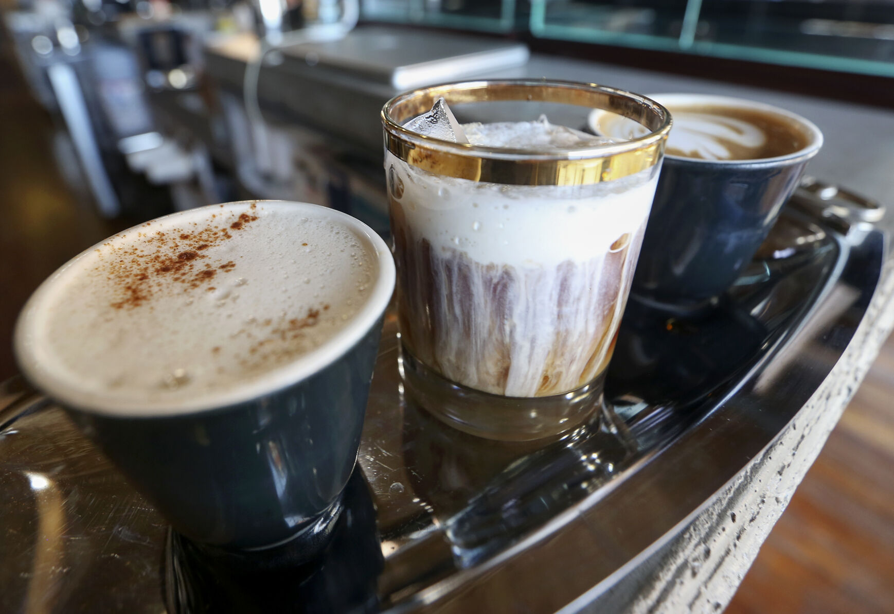 A coffee flight, consisting of a chai latte (from left), a semi-frozen sweet cream cold brew, and a Mayan Mocha at Devour Cafe in Dubuque.    PHOTO CREDIT: File photo