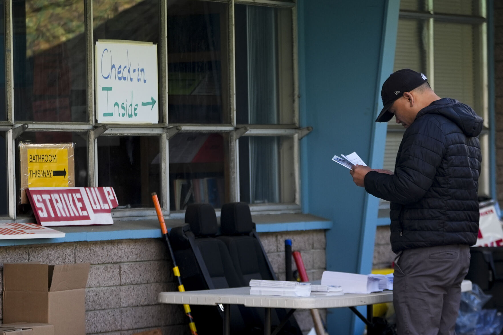 <p>A Boeing employee looks at informational pamphlets before heading in to vote on a new contract offer from the company, Wednesday, Oct. 23, 2024, at the Aerospace Machinists Union hall in Renton, Wash. (AP Photo/Lindsey Wasson)</p>   PHOTO CREDIT: Lindsey Wasson 