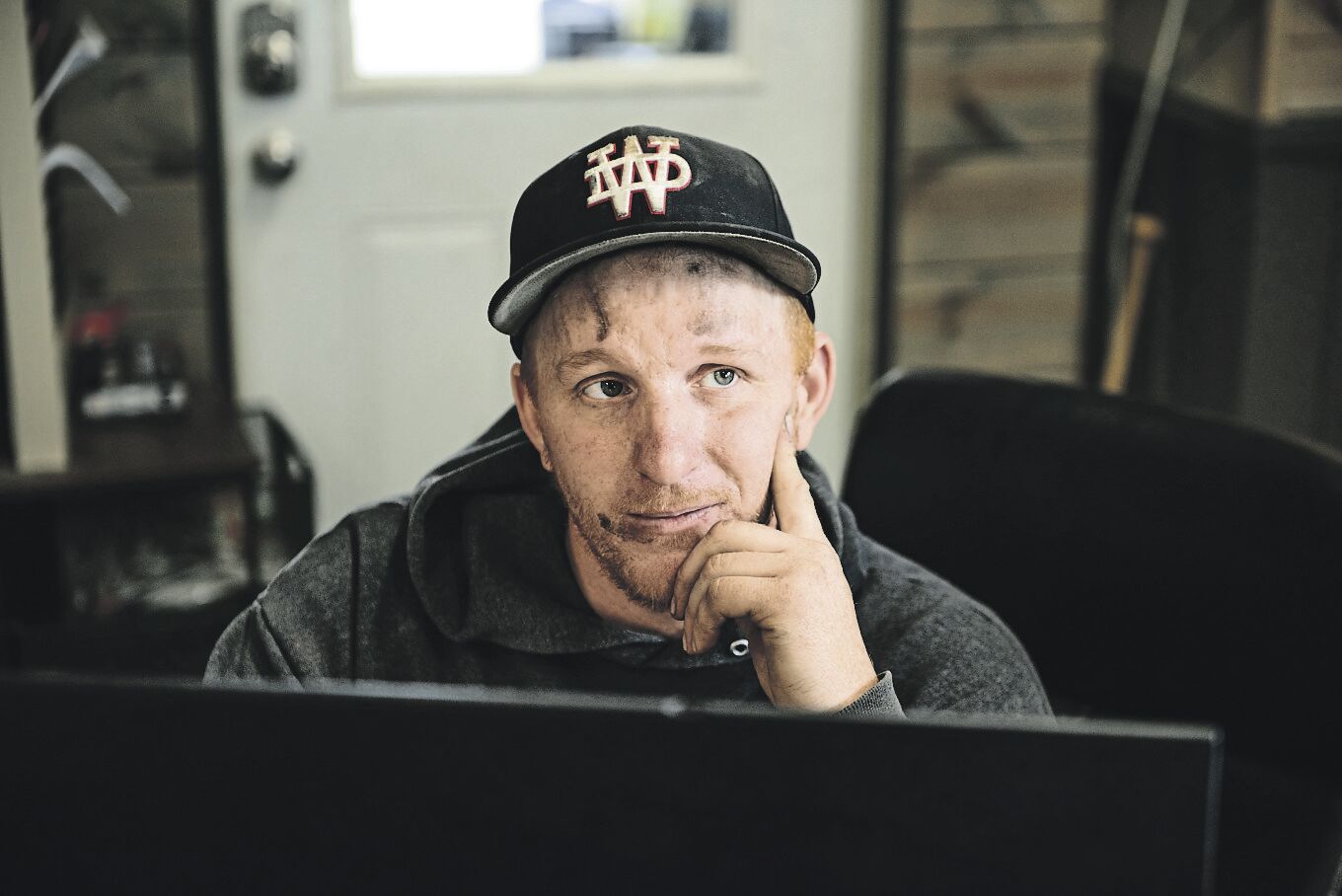 The man in perpetual motion, Delaney stops to talk with a customer while preparing his auto repair bill.    PHOTO CREDIT: Dave LaBelle • Staff Photo