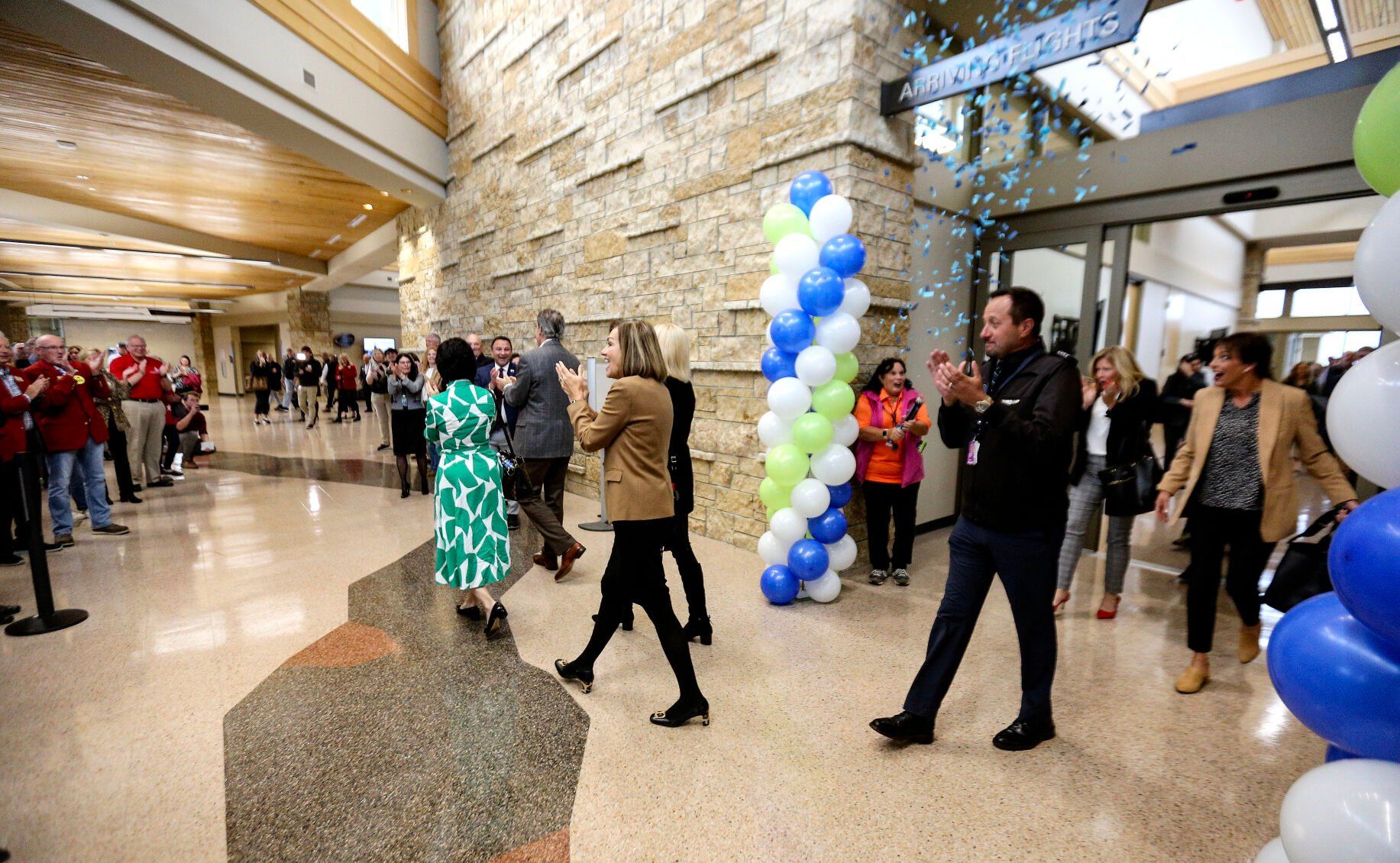 Iowa Gov. Kim Reynolds (center) and other representatives are welcomed as they arrive on Denver Air Connection