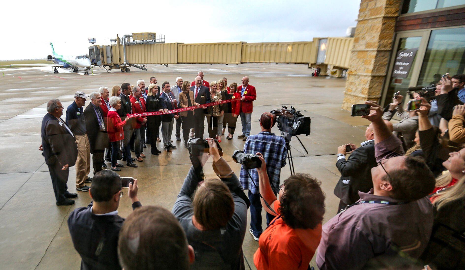 People gather for a ribbon ceremony for the first flight of Denver Air Connection at the Robert L. Martin Terminal on Monday in Dubuque.    PHOTO CREDIT: Dave Kettering