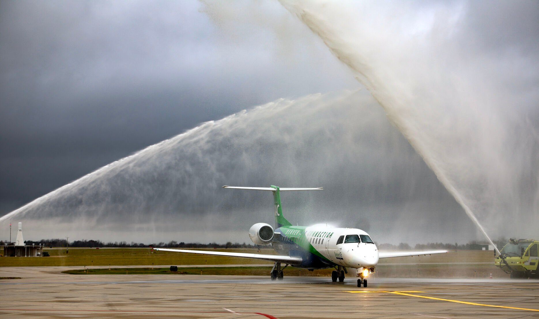 Water cannons shoot over the first daily flight of Denver Air Connection from Chicago to Dubuque as it taxis to the Capt. Robert L. Martin Terminal at Dubuque Regional Airport on Monday.    PHOTO CREDIT: Dave Kettering