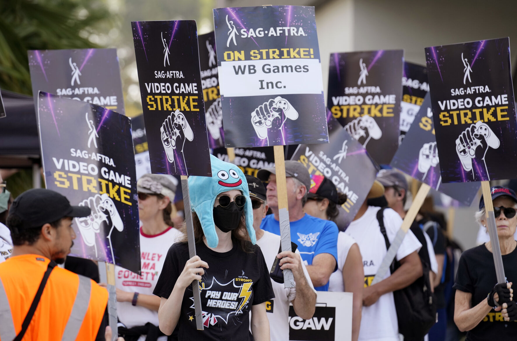 <p>FILE - Actor Sena Bryer, second from left, joins other demonstrators in a SAG-AFTRA video game actor strike picket line outside Warner Bros. Studios on Aug. 28, 2024, in Burbank, Calif. (AP Photo/Chris Pizzello)</p>   PHOTO CREDIT: Chris Pizzello - invision linkable, Chris Pizzello/Invision/AP