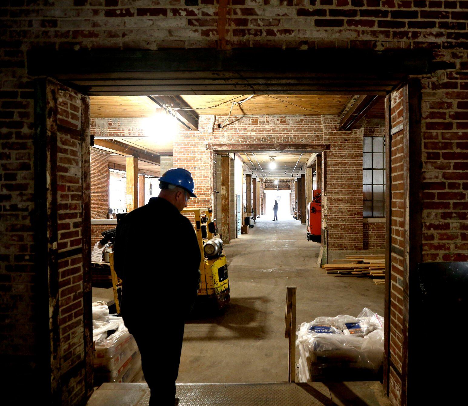 In May 2020, Lee Schroeder, site superintendent for Gronen Properties, gives a tour of Dupaco Community Credit Union’s $38.5 million renovation to transform the Voices building at 1000 Jackson St. into an operations center.    PHOTO CREDIT: TH file